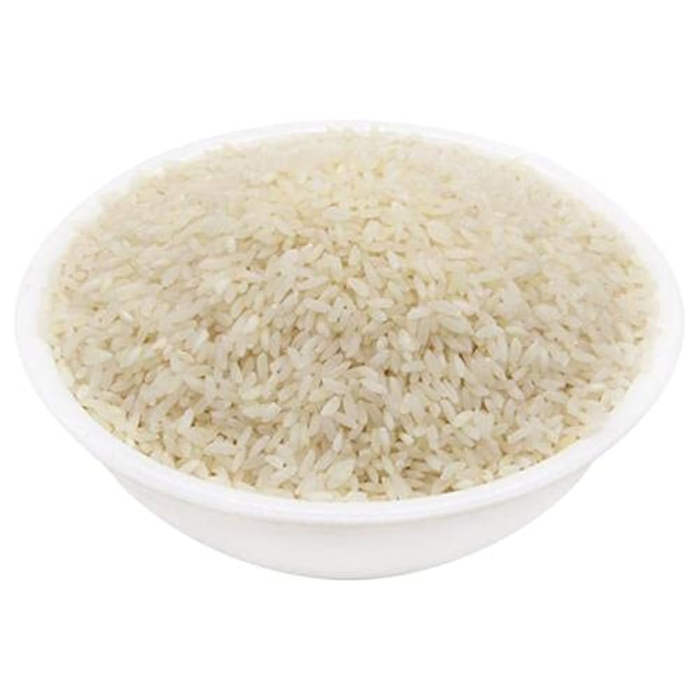 Tiny grains of Jeera Samba rice on a rustic background