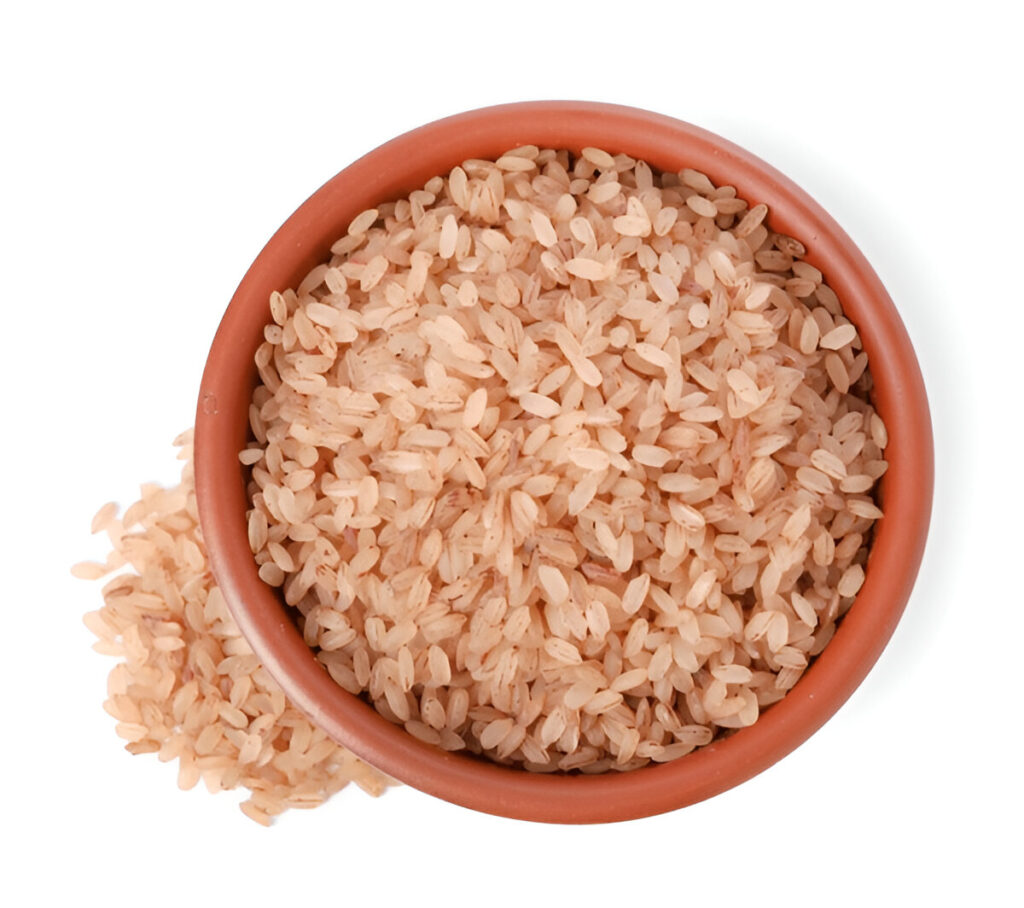 Thick reddish grains of Matta rice on a brass plate